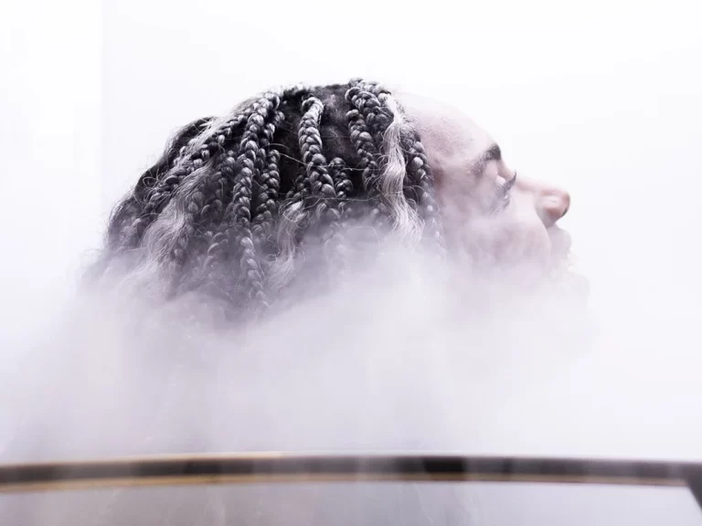 A woman with dreadlocks enjoying Cryotherapy at Restore Hyper Wellnes