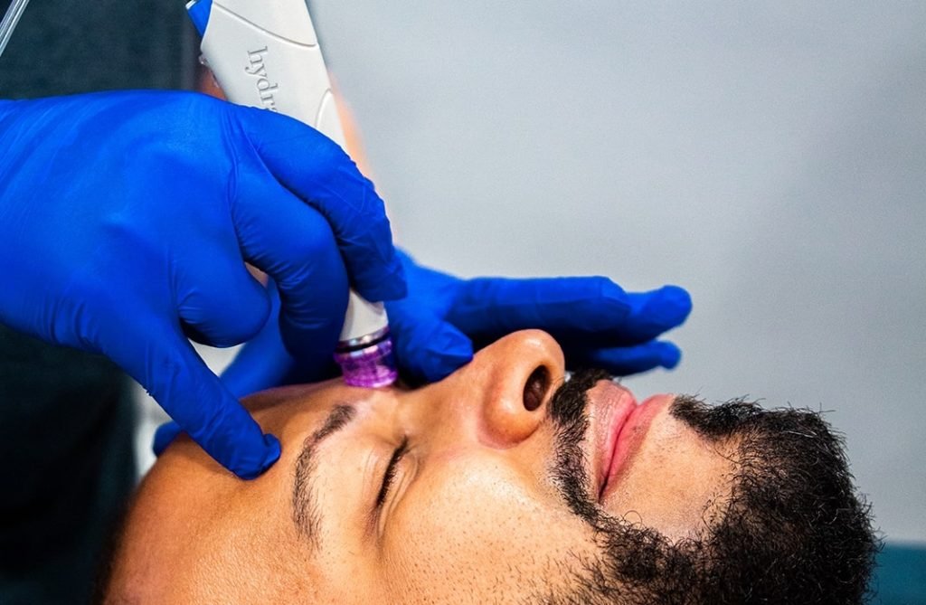 Man receiving HydraFacial treatment at Restore Hyper Wellness South Mt Pleasant