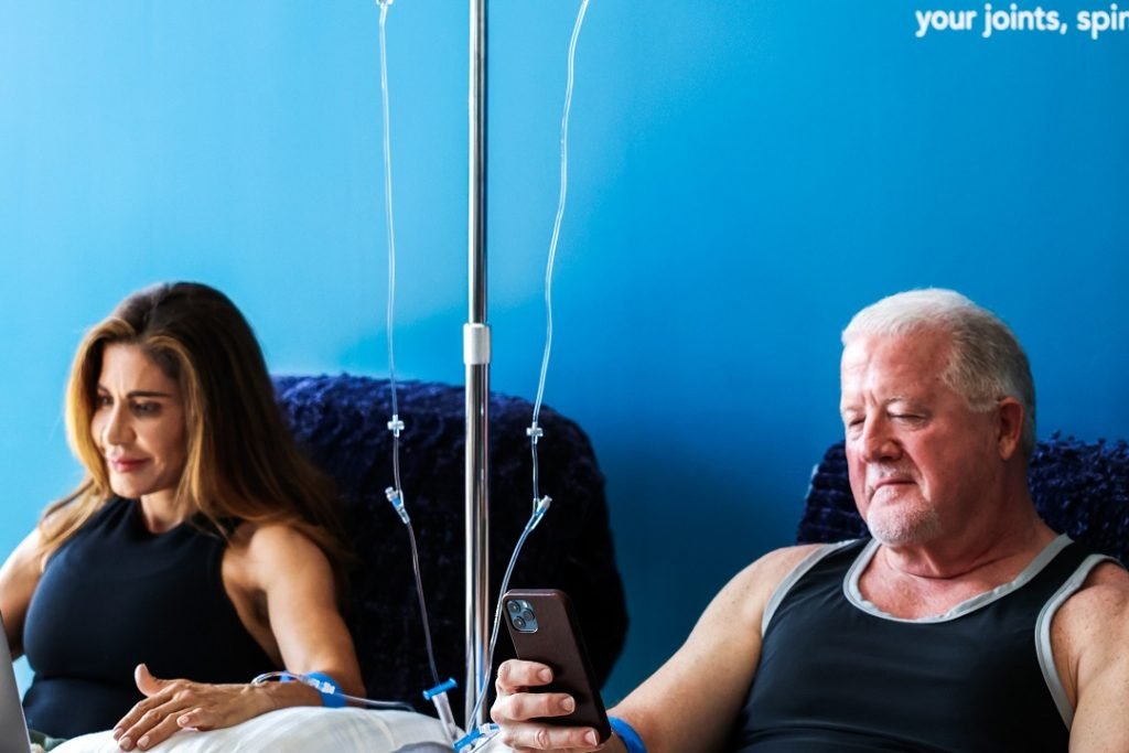 Woman and a man enjoying IV NAD therapy at Restore Wellness