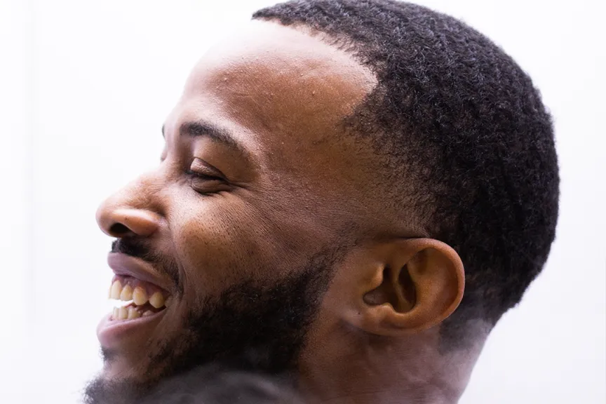 Man smiling with a white background.