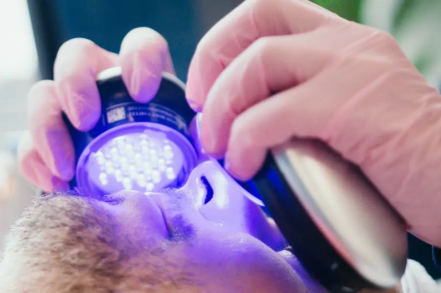 Someone under UV lights during a treatment.