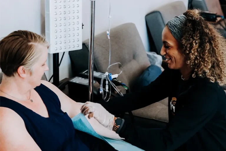 Two women during a preparation for an IV Therapy.