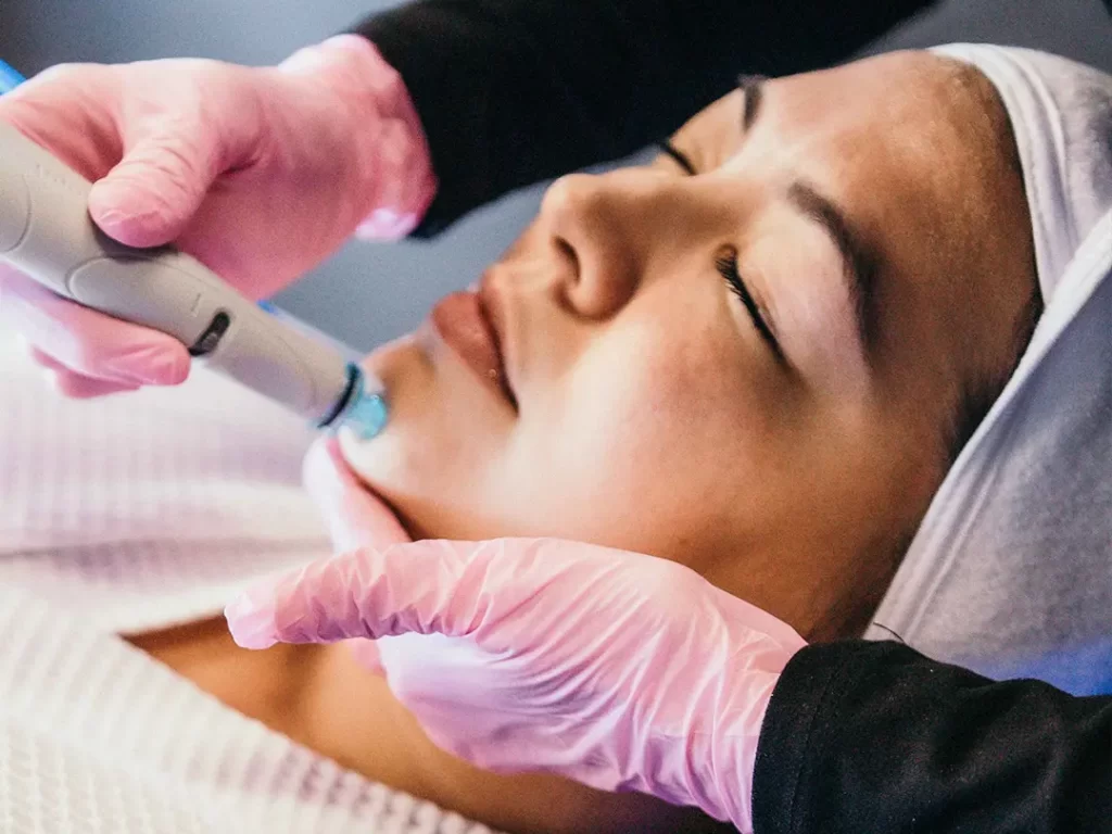 Woman relaxing during a hydra facial.