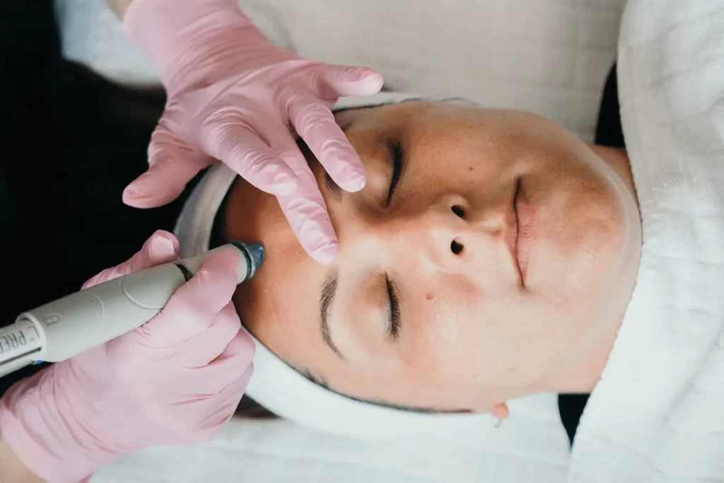 Young Woman With Eyes Closed Receiving A HydraFacial At Restore Hyper Wellness In South Mt Pleasant