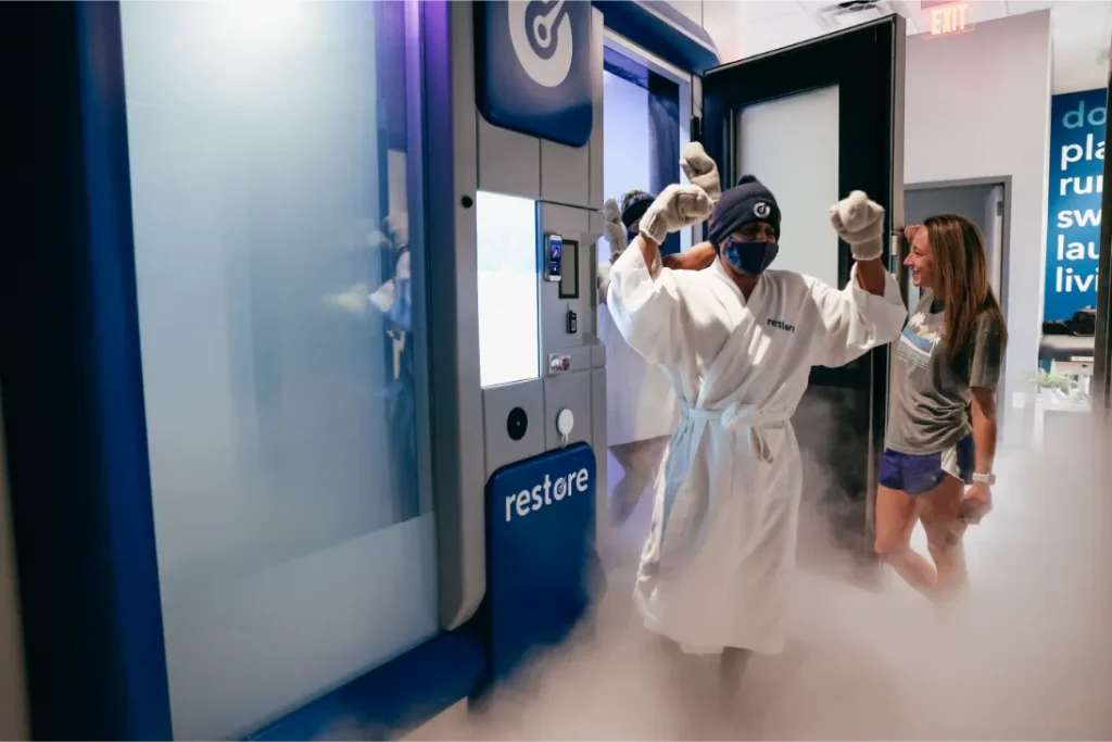 A man with wool gloves smiling during cryotherapy.