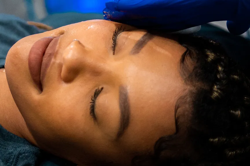 A beautiful woman gently receiving CryoFacial treatment at Restore South Mt Pleasant