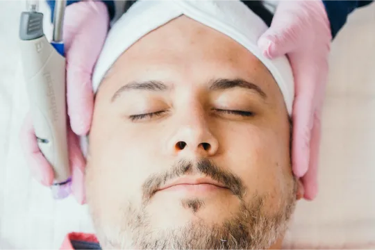 Man getting getting prepared for a hydra facial treatment.